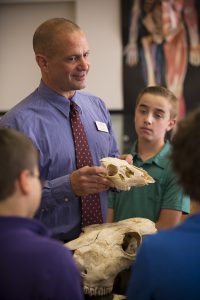 science teacher showing bones