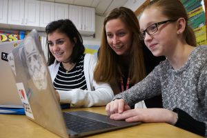 Middle School girls working with teacher
